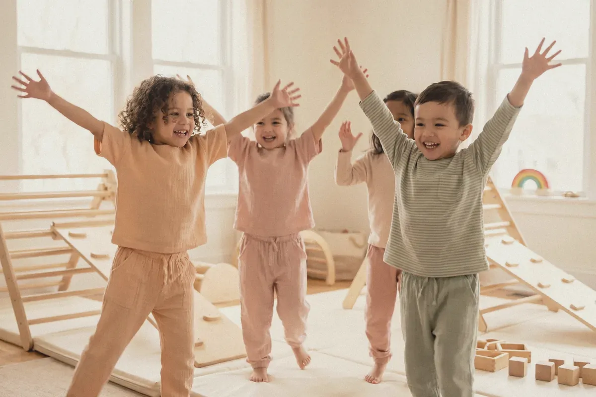Preschoolers dancing with their arms raised