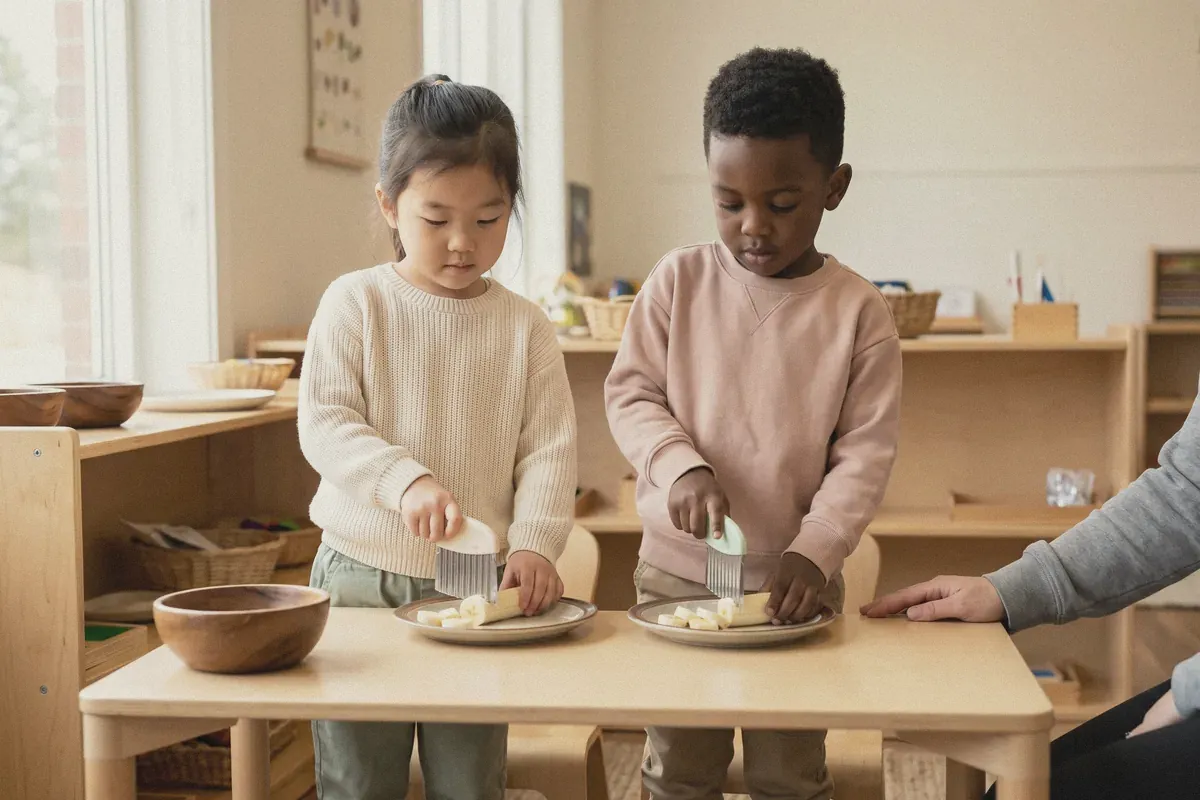Two children slicing banana for a snack